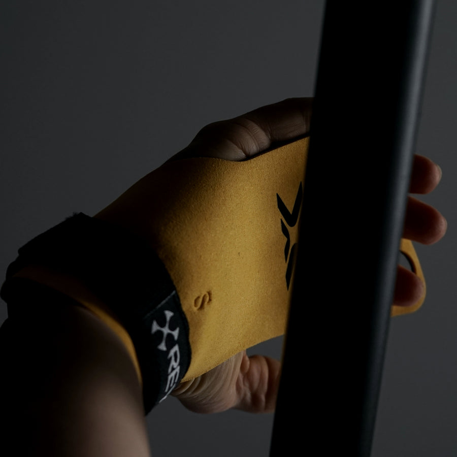 BumbleBee X3 Gymnastic Grips 3-hole shown worn on hand with pull up bar